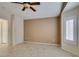 Bedroom with tile floors, light brown walls, ceiling fan and window with white shutters at 2007 High Mesa Dr, Henderson, NV 89012