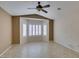 Bedroom with tile floor, ceiling fan, and bay window with white shutters at 2007 High Mesa Dr, Henderson, NV 89012