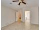 Bedroom with tile floor, ceiling fan, light brown walls, and two doors at 2007 High Mesa Dr, Henderson, NV 89012