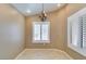 Dining area with tile floor, chandelier, tan walls, and white window shutters at 2007 High Mesa Dr, Henderson, NV 89012