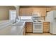 This is a kitchen with light wood cabinets, white appliances, and light countertops at 2007 High Mesa Dr, Henderson, NV 89012