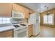 This kitchen has wooden cabinets, white appliances and is well lit with lots of counter space at 2007 High Mesa Dr, Henderson, NV 89012