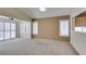 Open living room features carpet flooring, plantation shutters, and is open to dining area at 2007 High Mesa Dr, Henderson, NV 89012