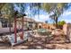 Private backyard with a round jacuzzi, patio and shade, surrounded by desert landscaping at 208 Lynbrook St, Henderson, NV 89012