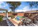 This landscaped backyard features a sparkling jacuzzi with waterfall and shaded patio for relaxing at 208 Lynbrook St, Henderson, NV 89012