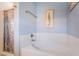 Bathroom featuring a bathtub with updated fixtures and a shower at 208 Lynbrook St, Henderson, NV 89012