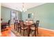Elegant dining room with a wooden table, chairs, and a stylish chandelier at 208 Lynbrook St, Henderson, NV 89012