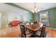 Open-concept dining area with a wooden table and chairs, flowing into the living room at 208 Lynbrook St, Henderson, NV 89012