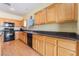 Well-lit kitchen boasting ample counter space, modern appliances, and stylish wood cabinetry at 208 Lynbrook St, Henderson, NV 89012