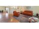 Open-concept living room with hardwood floors, stylish furniture, and bright, neutral walls at 208 Lynbrook St, Henderson, NV 89012