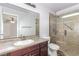 Bathroom featuring a single sink vanity and a glass-enclosed shower with a seat and neutral tile at 209 Eucalyptus Ln, Mesquite, NV 89027