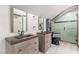 Modern bathroom featuring dual sink vanities and a beautifully tiled glass enclosed shower at 209 Eucalyptus Ln, Mesquite, NV 89027