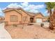 A well-maintained single-story home with desert landscaping, a two-car garage and a welcoming entrance at 209 Eucalyptus Ln, Mesquite, NV 89027