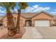 A front exterior of a single-story home featuring desert landscaping and a two-car garage at 209 Eucalyptus Ln, Mesquite, NV 89027