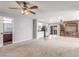 Spacious living room with neutral carpet, a ceiling fan with lighting, and a kitchenette at 209 Eucalyptus Ln, Mesquite, NV 89027