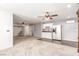 Spacious living room with light-colored carpet and kitchen area, ceiling fans and an air conditioning unit at 209 Eucalyptus Ln, Mesquite, NV 89027