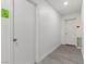 Bright hallway with fresh paint and gray flooring, with doors at either end, creating a seamless and inviting space at 214 S Maryland Pkwy, Las Vegas, NV 89101