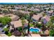 Inviting aerial view of a residential neighborhood showcasing a home with a backyard pool and lush landscaping at 2401 Rice Flower Cir, Las Vegas, NV 89134
