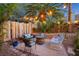 Charming backyard with outdoor seating, fire pit, and ambient string lights at 2401 Rice Flower Cir, Las Vegas, NV 89134
