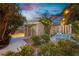Secluded backyard with storage shed, lush greenery, and ambient string lights at 2401 Rice Flower Cir, Las Vegas, NV 89134