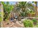 A serene backyard offers a cozy fire pit area with comfortable seating, surrounded by lush landscaping at 2401 Rice Flower Cir, Las Vegas, NV 89134