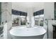 Bright bathroom with a modern soaking tub, marble accents, and a view of the neighborhood at 2401 Rice Flower Cir, Las Vegas, NV 89134