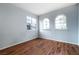 Bright bedroom with hardwood floors featuring two large, arched windows at 2401 Rice Flower Cir, Las Vegas, NV 89134