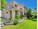 Inviting two-story home with a manicured lawn, a covered front porch, and a two-car garage at 2401 Rice Flower Cir, Las Vegas, NV 89134