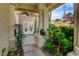 Charming front entrance with a double door, decorative columns, and lush landscaping leading to a welcoming facade at 2401 Rice Flower Cir, Las Vegas, NV 89134