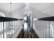 Bright upper level hallway with wood-look floors, white railing, and a view into a bedroom at 2401 Rice Flower Cir, Las Vegas, NV 89134
