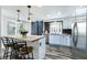 Updated kitchen with stainless appliances, island with bar seating, and modern sliding barn door at 2401 Rice Flower Cir, Las Vegas, NV 89134