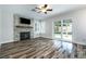 Cozy living room with stone fireplace, ceiling fan, and sliding glass doors to the backyard at 2401 Rice Flower Cir, Las Vegas, NV 89134