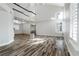 Bright, spacious living area with high ceilings, wood-look flooring, and abundant natural light at 2401 Rice Flower Cir, Las Vegas, NV 89134