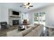 Cozy living room with a stone fireplace, wood mantel, and sliding glass doors to the backyard at 2401 Rice Flower Cir, Las Vegas, NV 89134