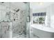 Bright bathroom with a luxurious tub, a frameless glass shower, and stylish finishes at 2401 Rice Flower Cir, Las Vegas, NV 89134