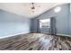 Spacious main bedroom featuring vaulted ceiling, ceiling fan, and beautiful hardwood floors at 2401 Rice Flower Cir, Las Vegas, NV 89134