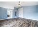 Spacious bedroom with light blue walls, hardwood floors, and an ensuite bathroom at 2401 Rice Flower Cir, Las Vegas, NV 89134
