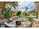 Charming outdoor space featuring a stone fire pit, comfortable seating, and string lights, perfect for entertaining guests at 2401 Rice Flower Cir, Las Vegas, NV 89134