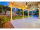 Covered patio with ceiling fans overlooking a well-manicured lawn and backyard at 2401 Rice Flower Cir, Las Vegas, NV 89134
