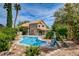 Stunning backyard with a large swimming pool, manicured landscaping, and relaxing lounge areas at 2401 Rice Flower Cir, Las Vegas, NV 89134