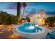 Beautiful backyard pool with palm trees and lighting, ideal for relaxation and outdoor fun at 2401 Rice Flower Cir, Las Vegas, NV 89134