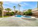 Backyard pool and spa surrounded by mature landscaping, providing a private outdoor retreat at 2401 Rice Flower Cir, Las Vegas, NV 89134