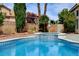 Inviting backyard pool and spa with lush landscaping and tranquil privacy wall at 2401 Rice Flower Cir, Las Vegas, NV 89134
