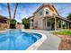 Beautiful backyard with a refreshing swimming pool, featuring a covered patio, and lush greenery for outdoor enjoyment at 2401 Rice Flower Cir, Las Vegas, NV 89134