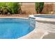Gorgeous pool and spa combo with stone waterfall and lush backyard at 2401 Rice Flower Cir, Las Vegas, NV 89134