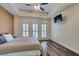 Inviting bedroom with wood floors, tray ceiling, and shuttered windows at 2405 W Serene Ave # 236, Las Vegas, NV 89123