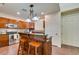 Well-equipped kitchen with wood cabinets, stone countertops, stainless steel appliances, and breakfast bar at 2405 W Serene Ave # 236, Las Vegas, NV 89123