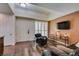 Cozy living room featuring hardwood floors, comfortable seating, and a wall-mounted TV at 2405 W Serene Ave # 236, Las Vegas, NV 89123