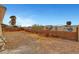 Wide angle shot of a gravel backyard, brick wall and palm trees at 2435 Paddock Ln, Las Vegas, NV 89156