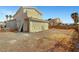 Wide shot of a gravel backyard with stucco houses at 2435 Paddock Ln, Las Vegas, NV 89156
